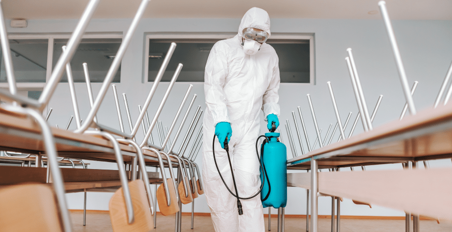 40aff4d5 man sterile uniform with gloves mask holding sprayer spraying with disinfectant floor classroom 1